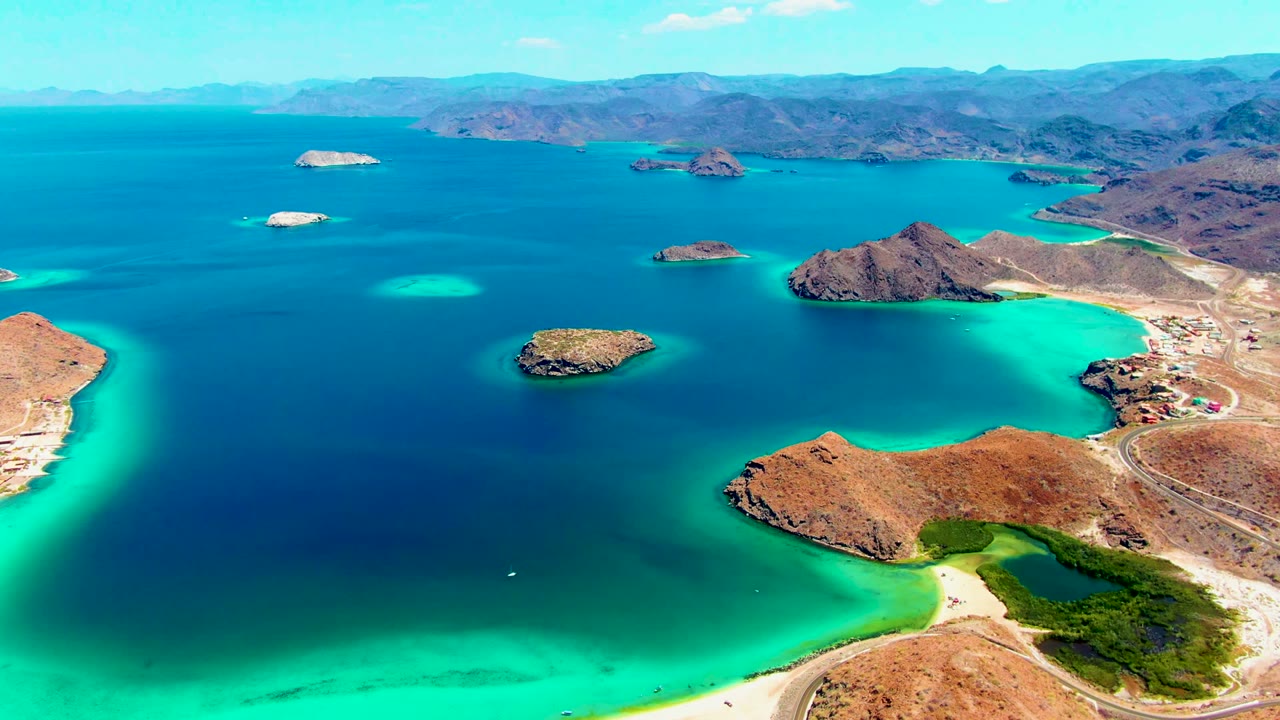 Wide aerial coastline with small islands and turquoise shallows