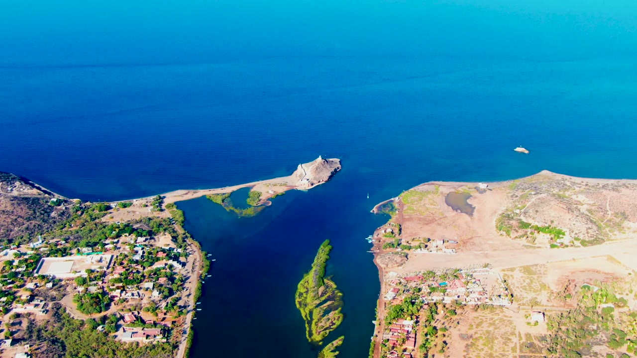 High aerial view of the same coastal channel with land on both sides.