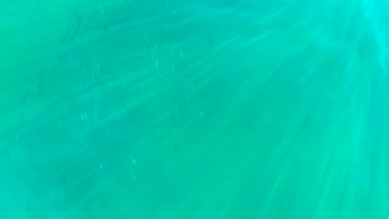 Clear turquoise water with brighter light streaks.