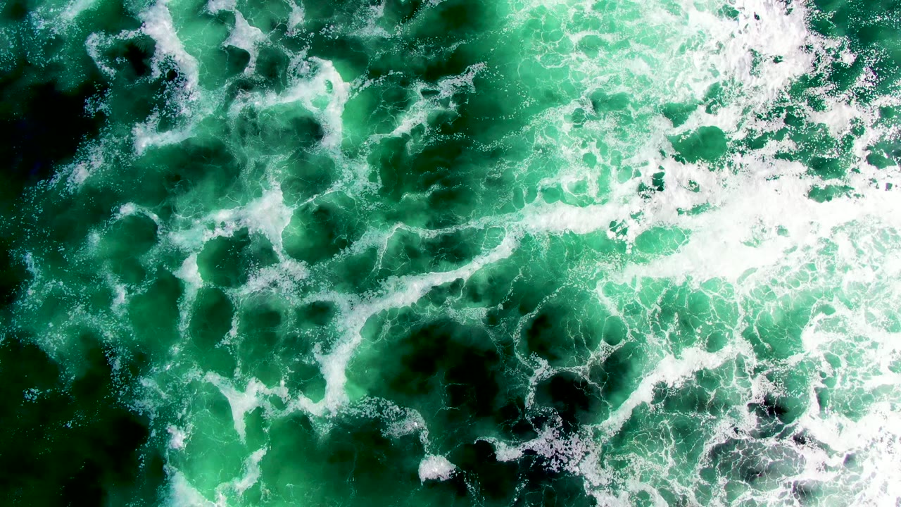 Turquoise water churned with white foam