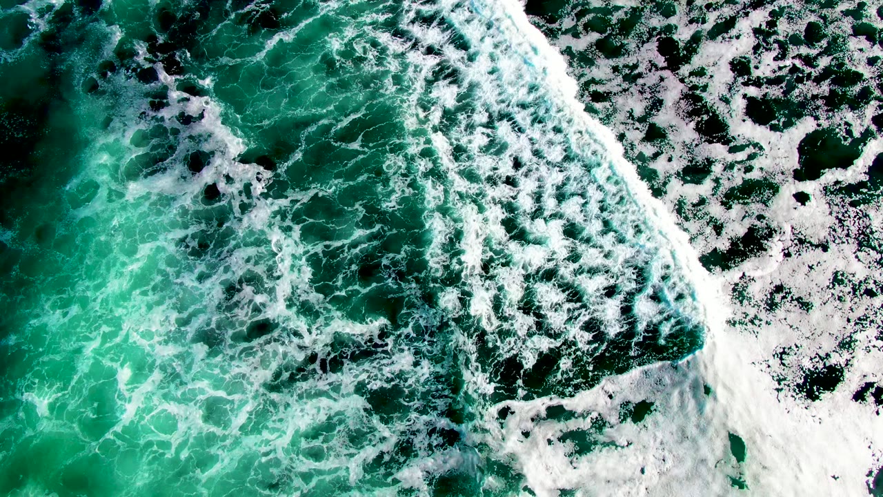 Foamy wave line over green ocean water