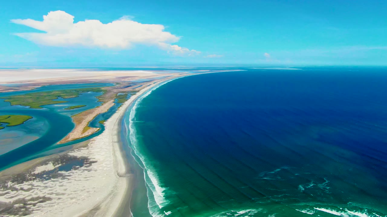 Third frame holds a broad La Bocana coastal view, with sand flats and lagoon water to the left, a narrow beach strip through the center, dark ocean water to the right, and no visible people.