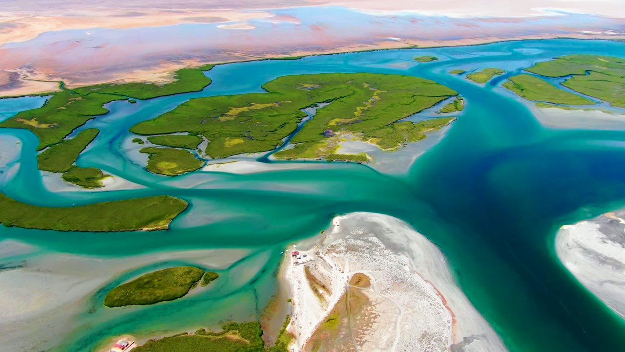 Third frame presents a broad deep-blue water channel on the right, green tidal islands across the middle, pale sandbars below, and no visible people in La Bocana.
