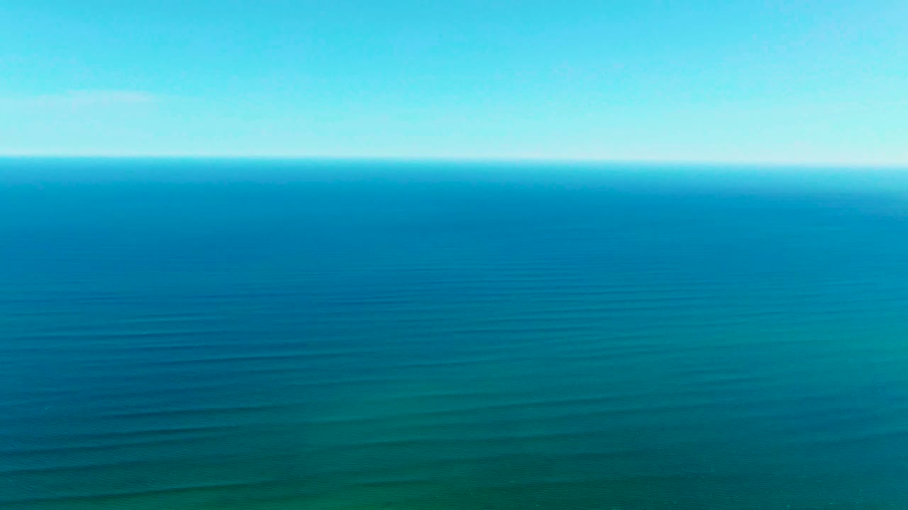 Open ocean surface with horizon and subtle wave bands