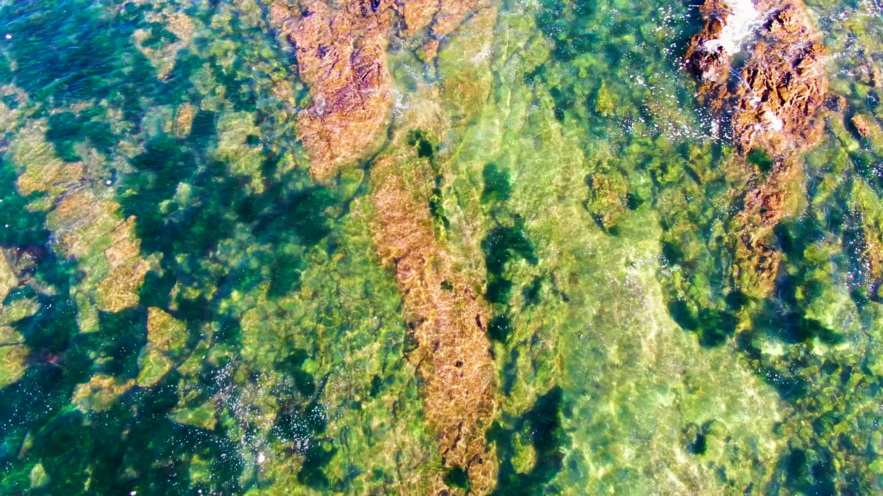 Rock ledges under rippling turquoise water