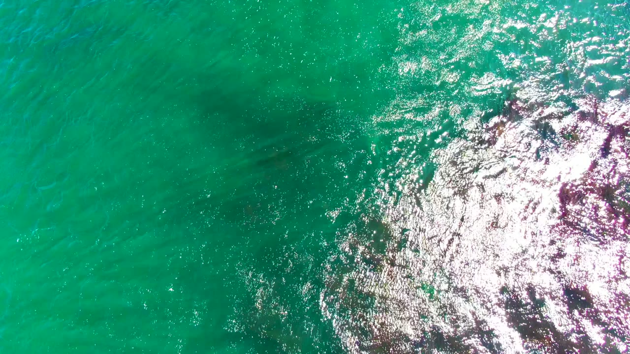 Open turquoise water with bright reflected sunlight