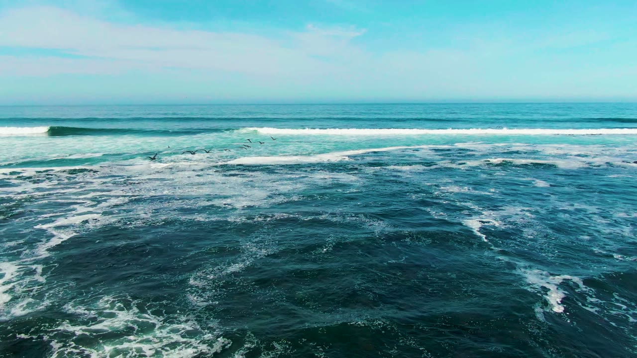 A wide La Bocana ocean frame shows long white surf bands near the horizon and darker rippled water in the foreground, with no visible people.