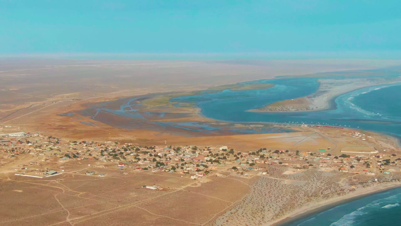 Third frame shows La Bocana from a high angle, with low buildings in the foreground, lagoon channels across the middle distance, surf at right, and no visible people.