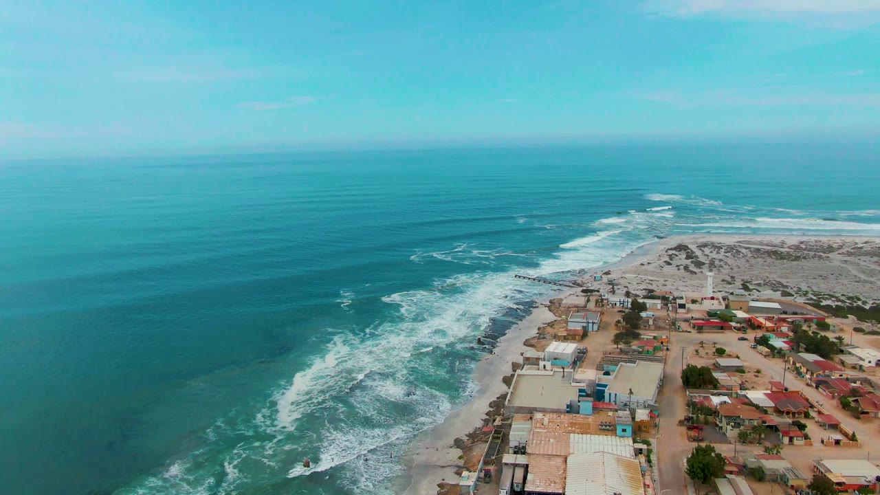 Drone view of surf lines and beachside buildings