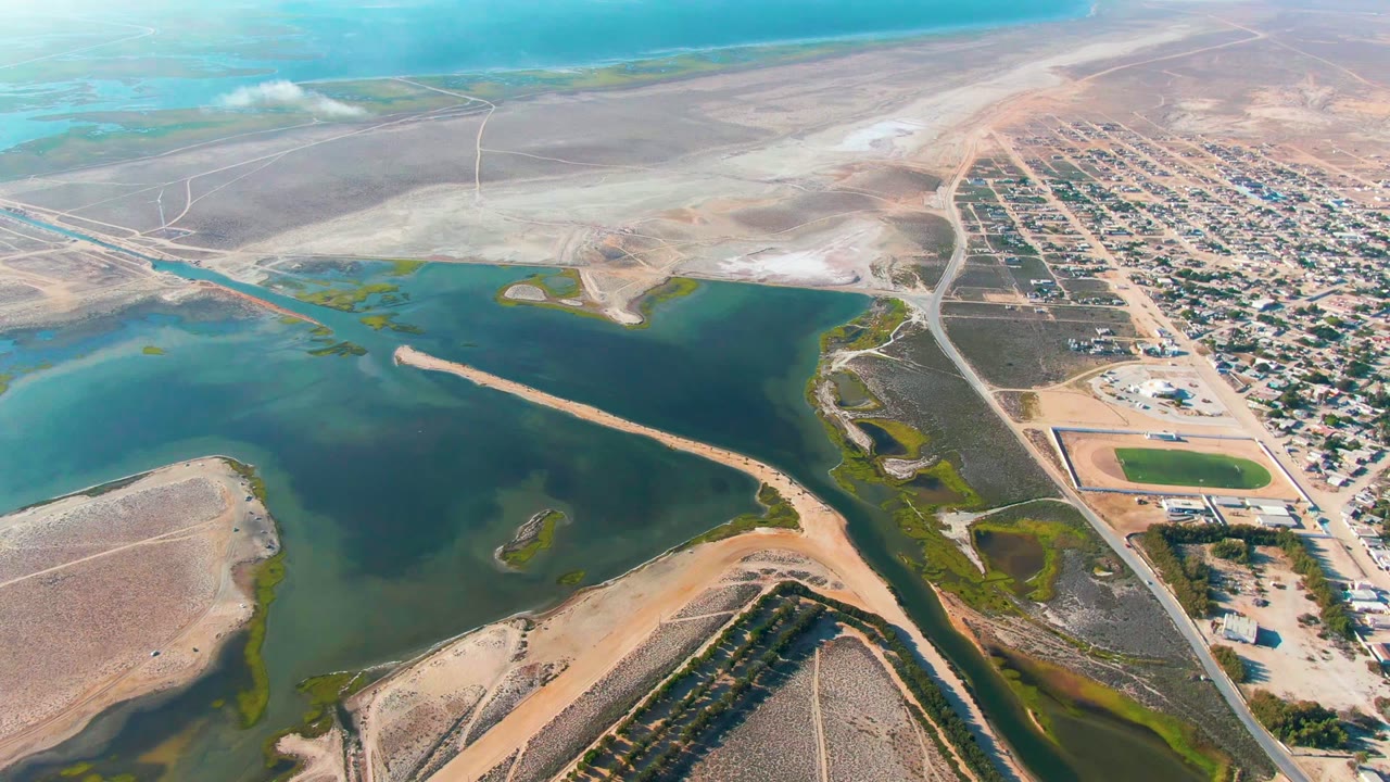 Aerial lagoon view with sandbars and a town edge.