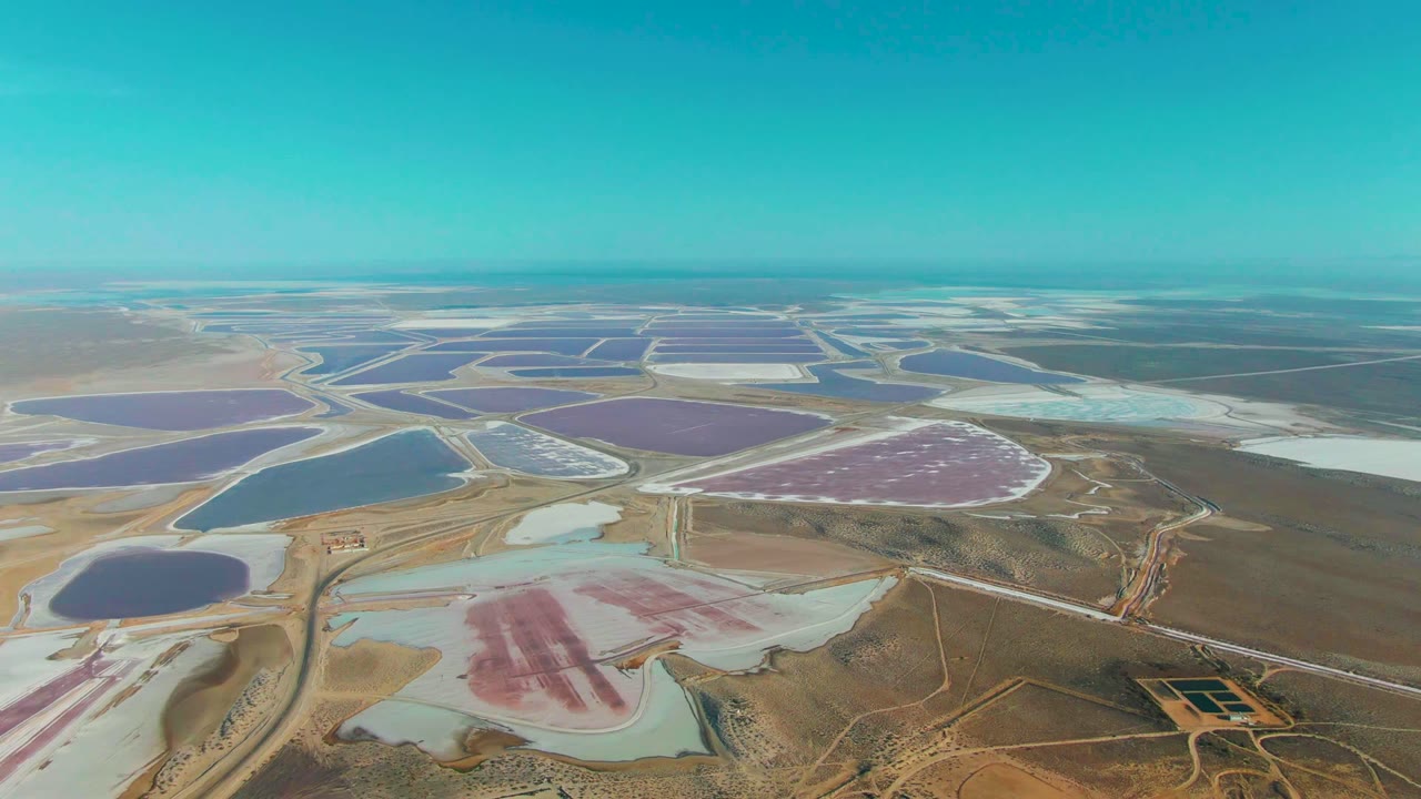 Drone view of pink, purple, blue, and white salt basins