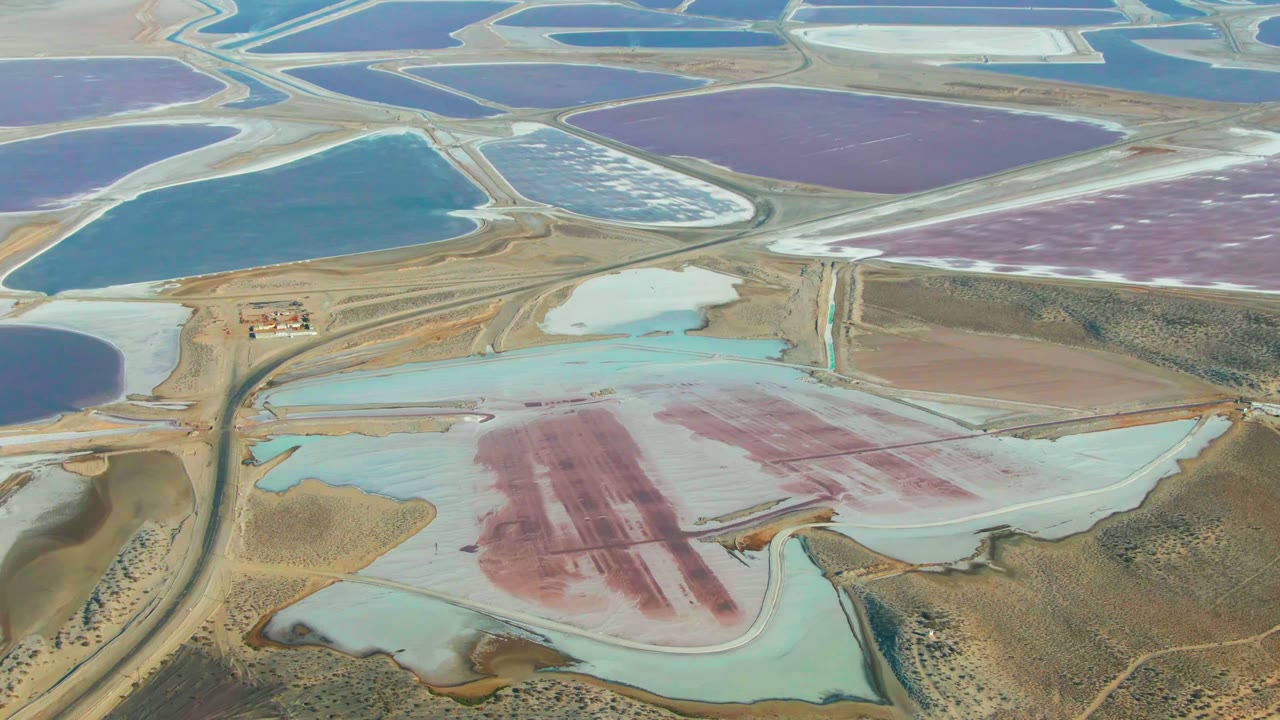 Salt ponds divided by berms with pink and turquoise basins