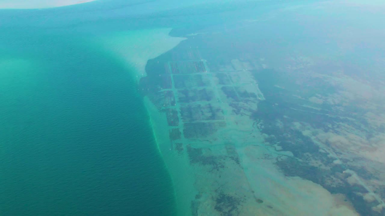 Turquoise water and rectangular coastal grid seen from high above