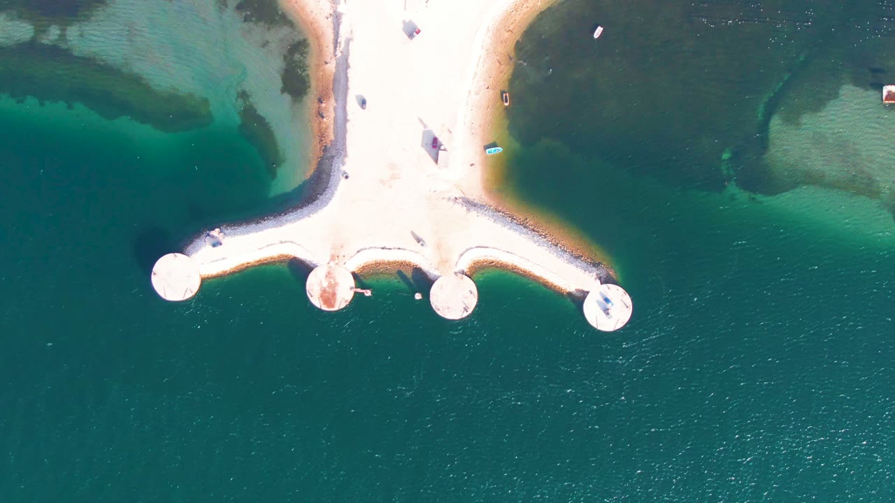Jetty over green-blue shallow water