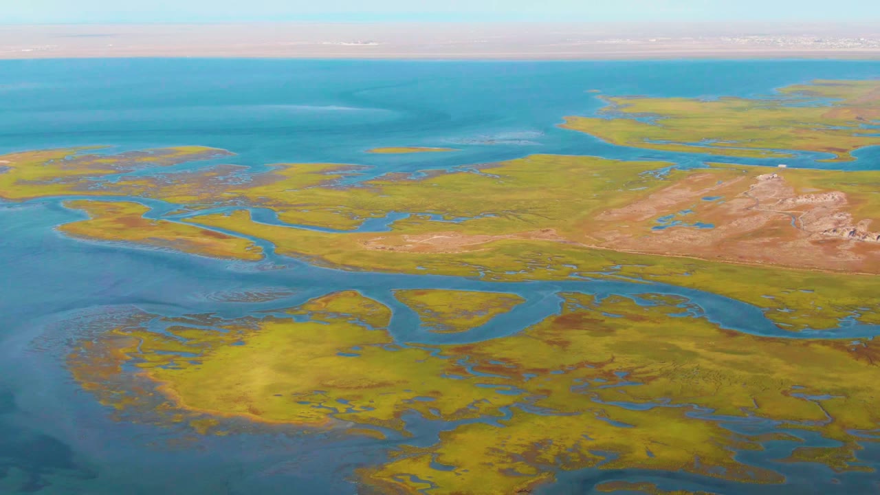 Coastal marsh islands with winding blue channels.