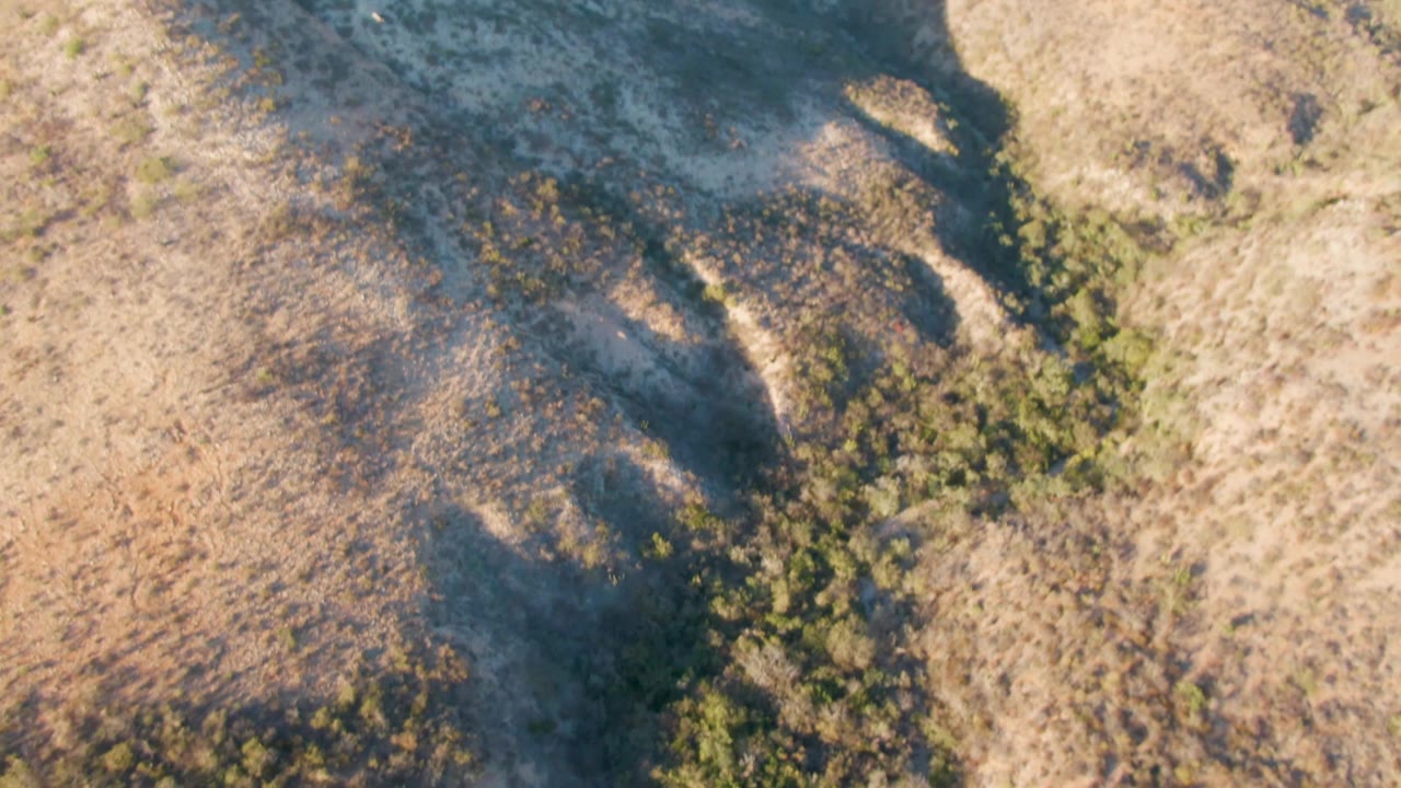 Aerial view across shadowed arid hills