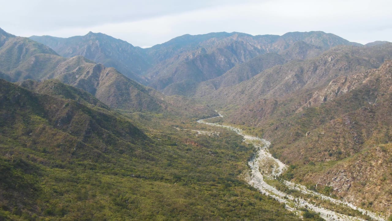 River valley seen from above with mountains filling the background.