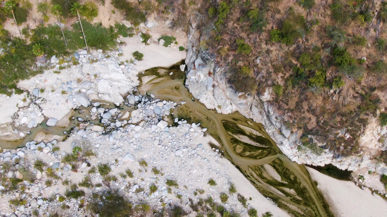 Overhead river channel winding through pale rocks and dry scrub.