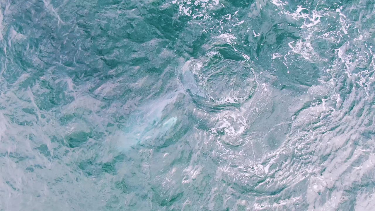 Turquoise ocean surface with circular ripples