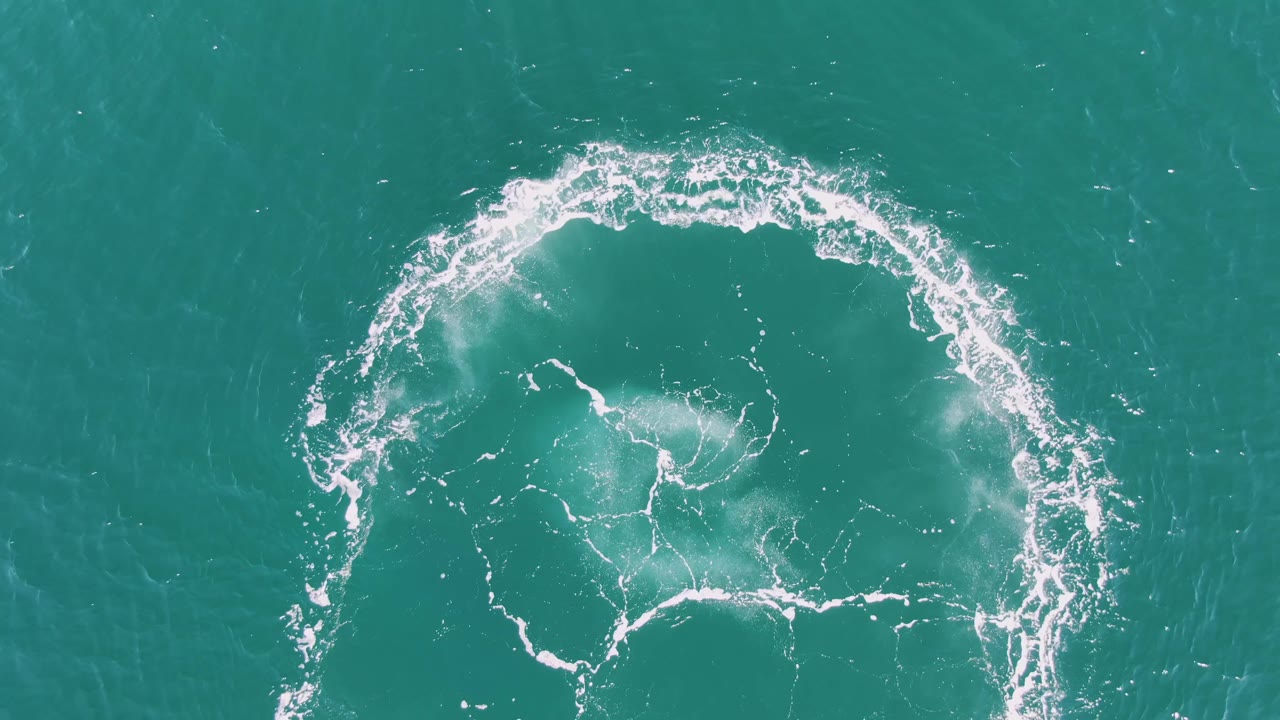 At three seconds, the overhead Buzzards Beach frame shows a partial circular wake drifting lower in the composition, with softer white foam and no visible people.
