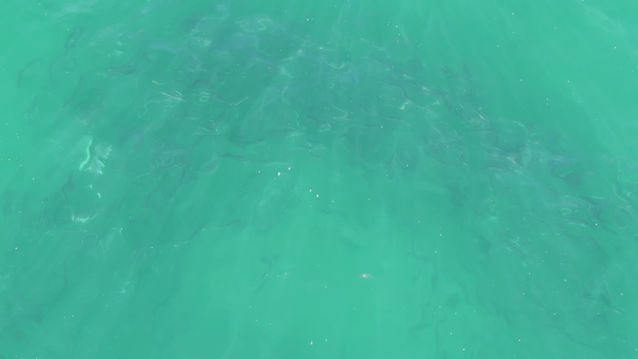 Clear turquoise water with subtle lower-frame ripples