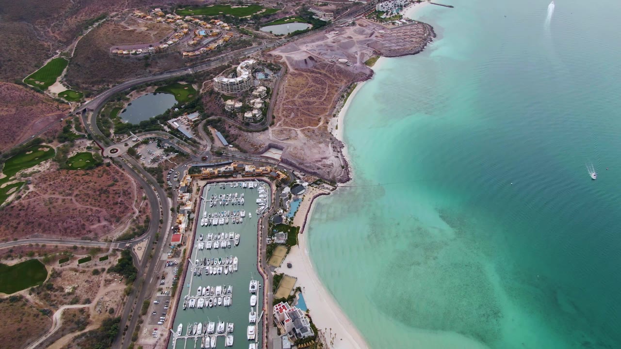 Aerial marina view with beach and bright turquoise shallows