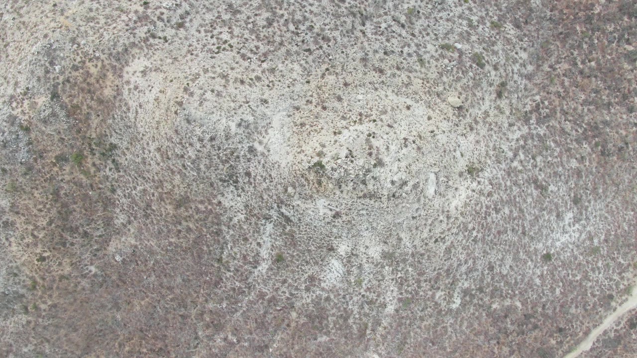 Second overhead frame at Punta Gorda Beach, Baja California Sur, with pale mineral staining concentrated near the upper and center areas of dry rocky ground and no visible people.