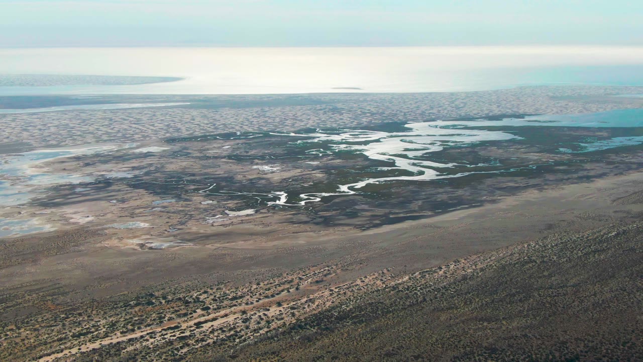 High oblique view of a river winding through coastal flats.