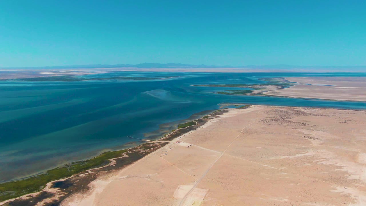 Wide drone view of empty sandy shore and ocean