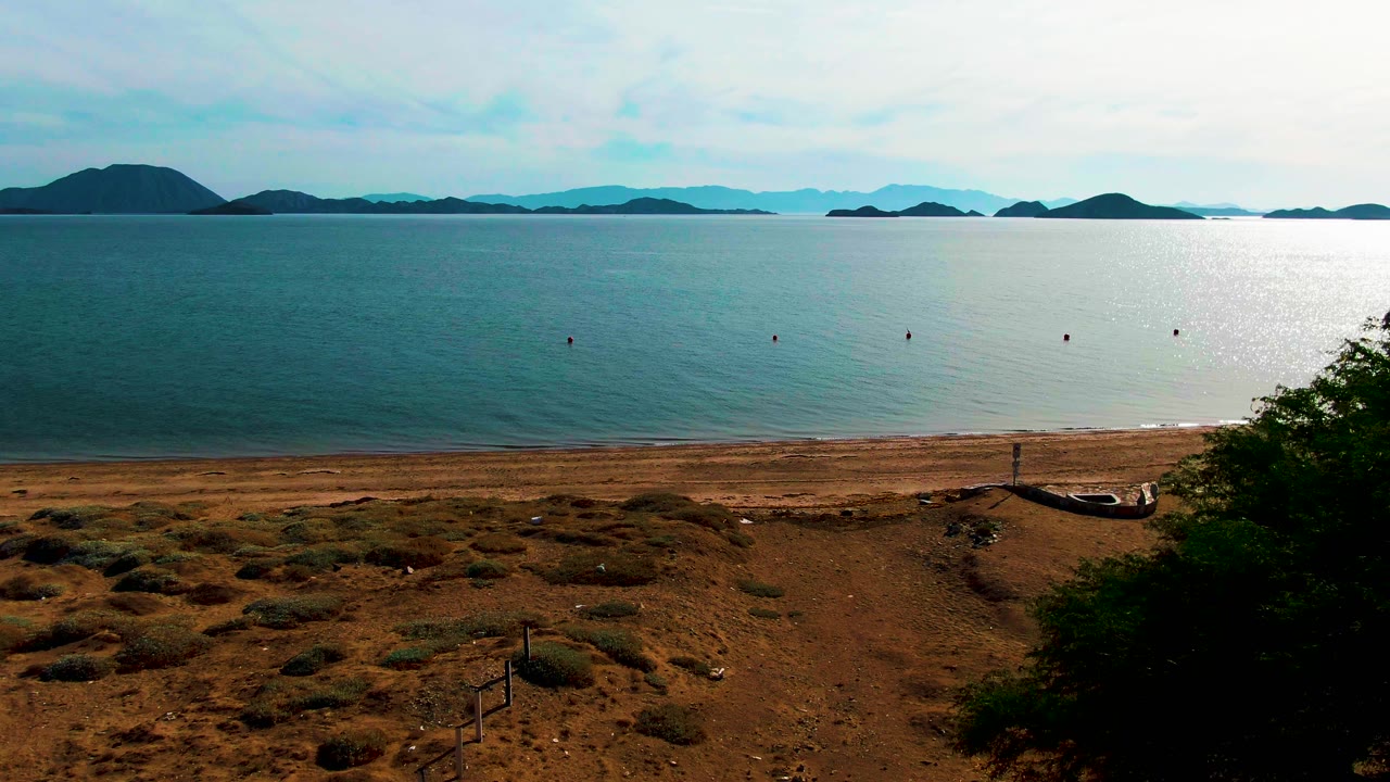 Open bay with bright water reflection and sandy shore