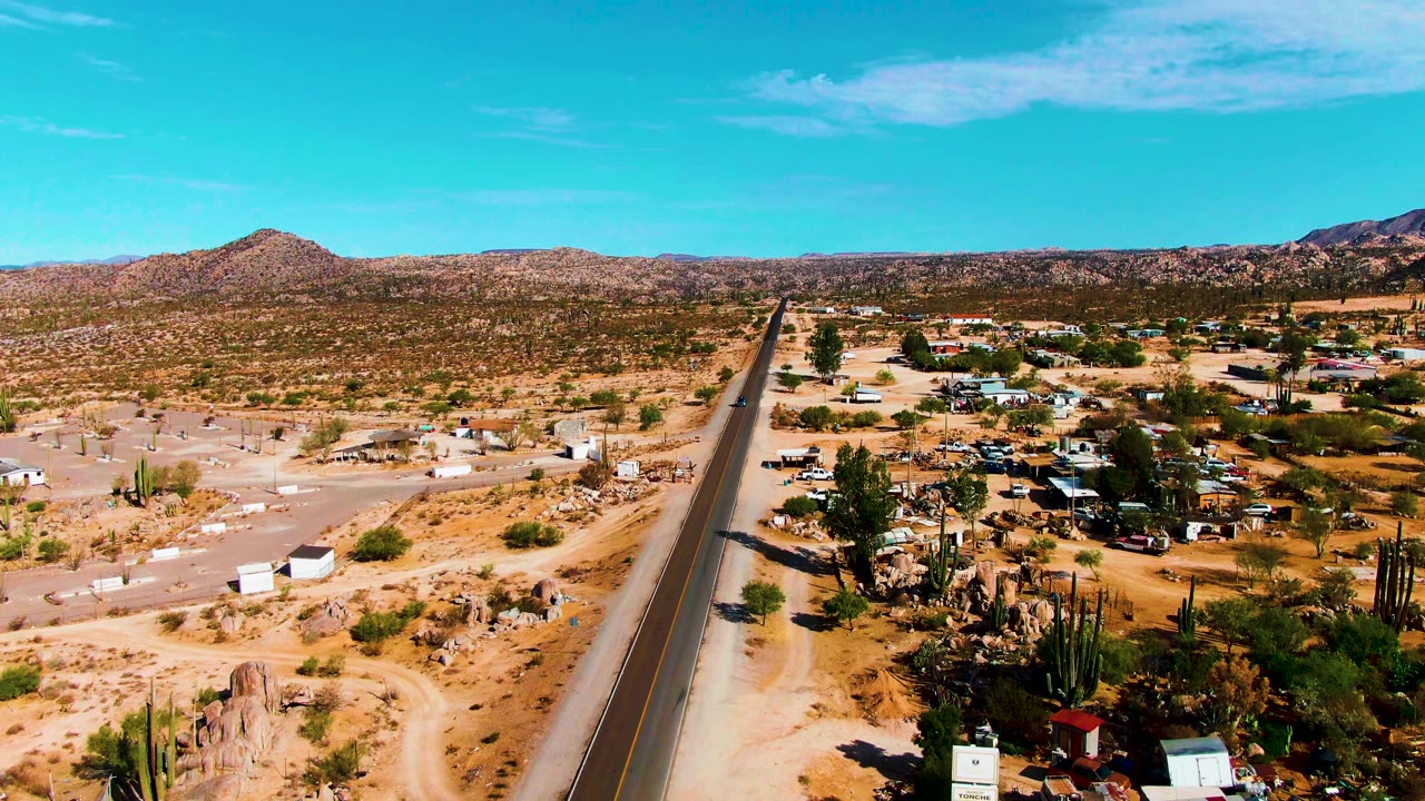 Desert road and roadside buildings viewed from above