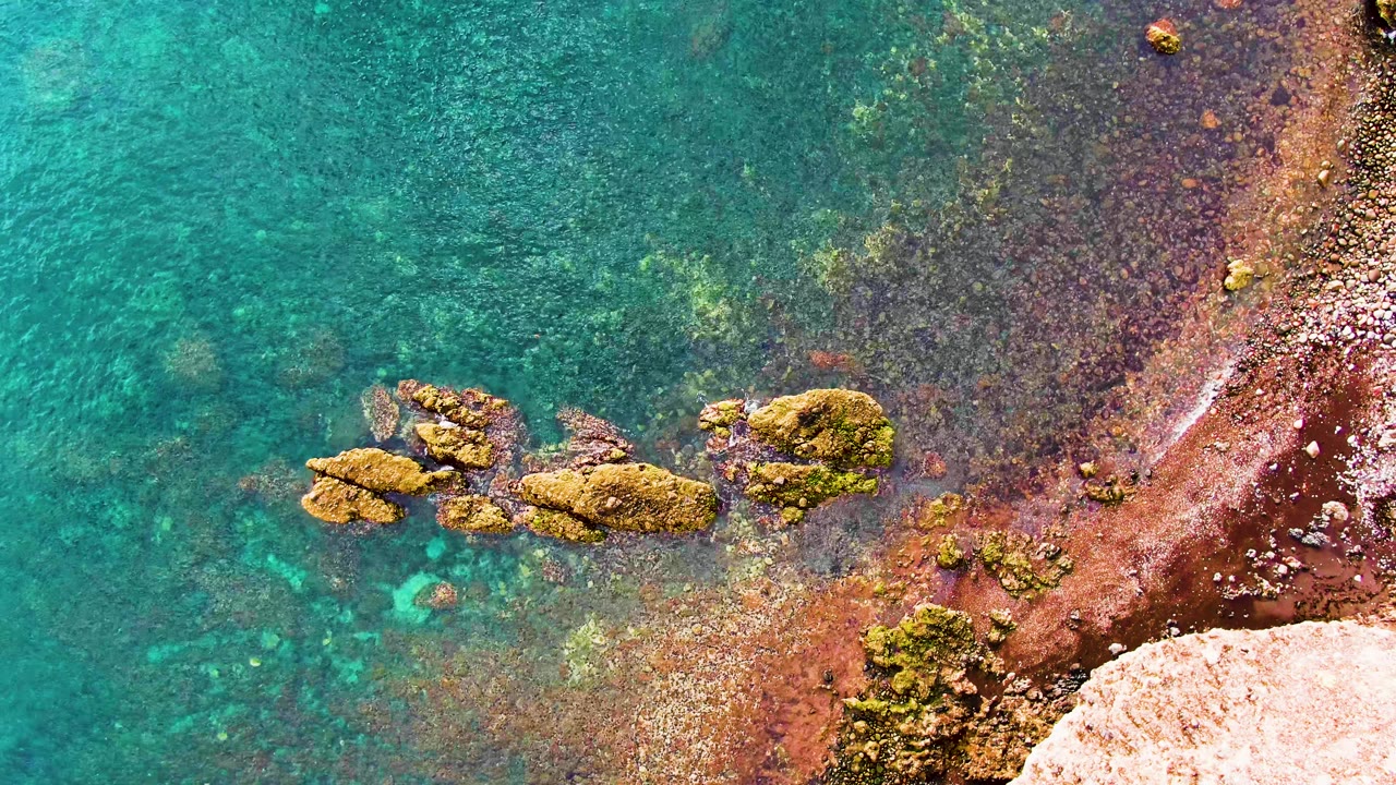 Overhead turquoise water and rocky shoreline