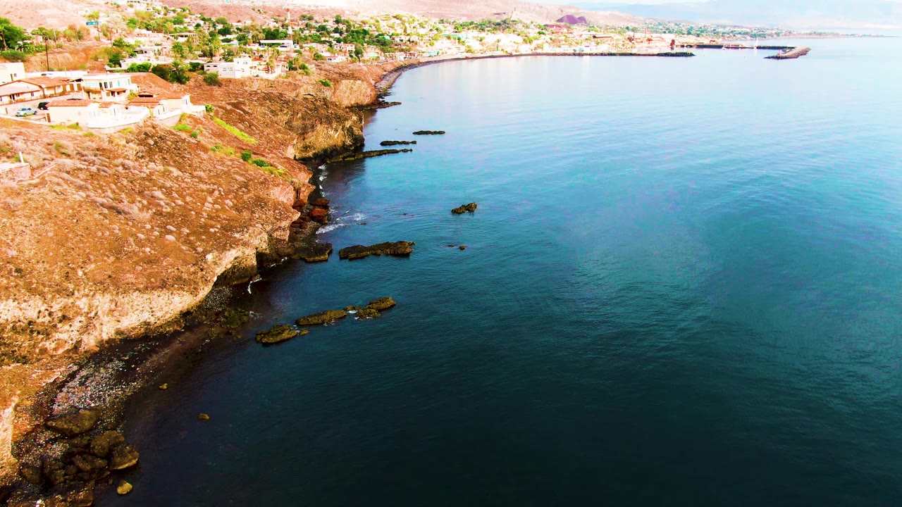 Aerial coastline with rocky shore and calm open water