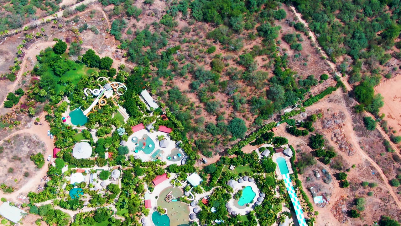 Overhead view of a water park beside dry hills