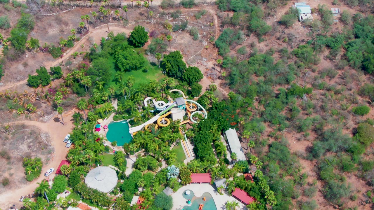 Overhead water park view with a road and cars near the lower edge.