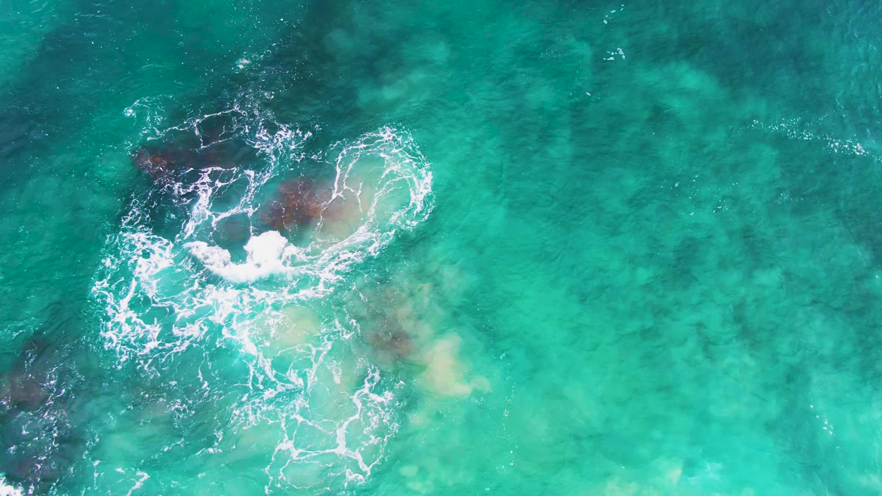 Overhead surf spreading across submerged rocks