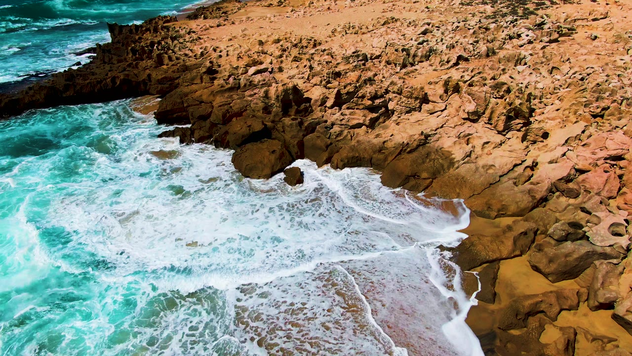 Surf foam beginning to recede from the cove