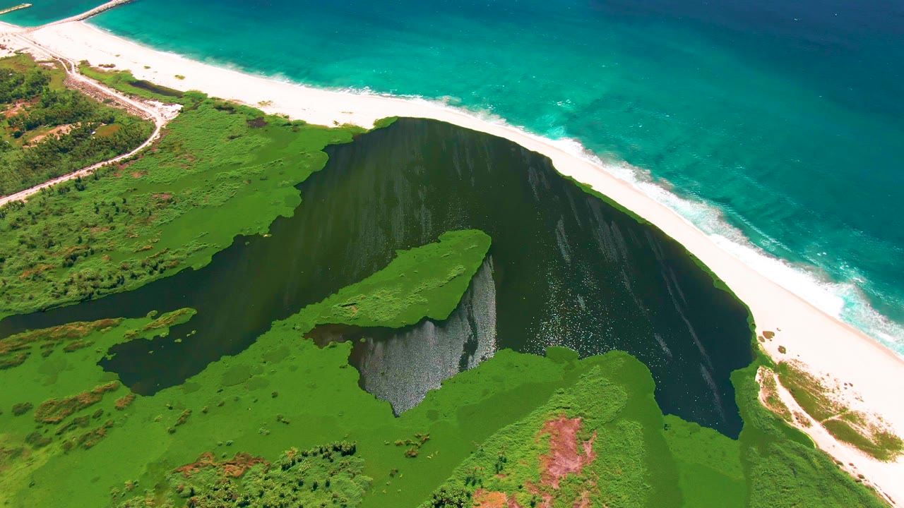 High aerial view of beach separating lagoon and ocean