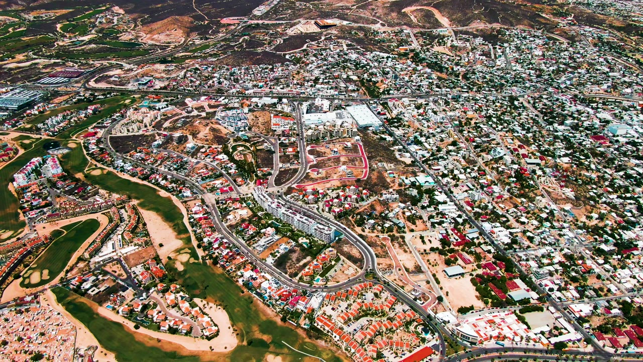 Aerial view of golf course water features and nearby houses.