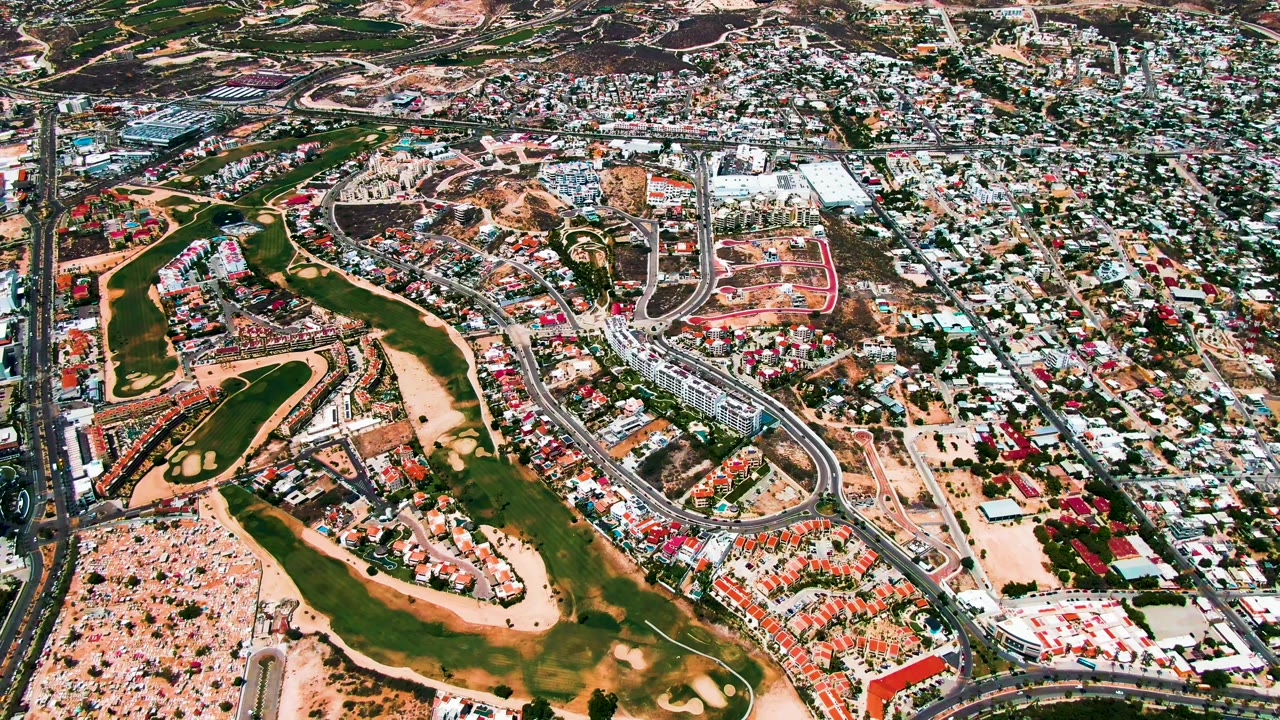 Golf course and neighborhood from above with roads crossing the scene