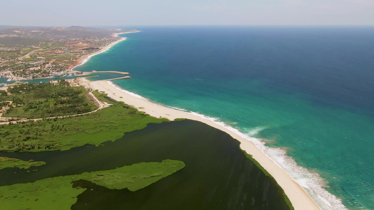 Aerial coastal landscape with beach, lagoon water, and blue ocean