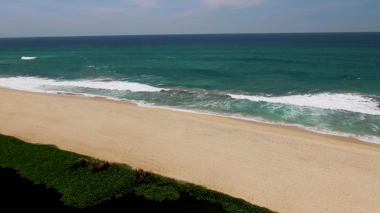 Elevated view of waves reaching a sandy beach