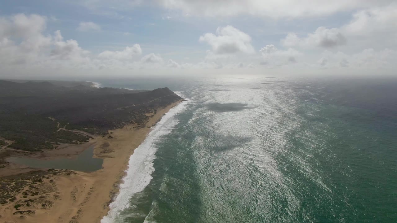 One second into the Punta Gordo clip, the surf line sits nearer the center with a bright strip of reflected light across the green-blue ocean and no visible people.