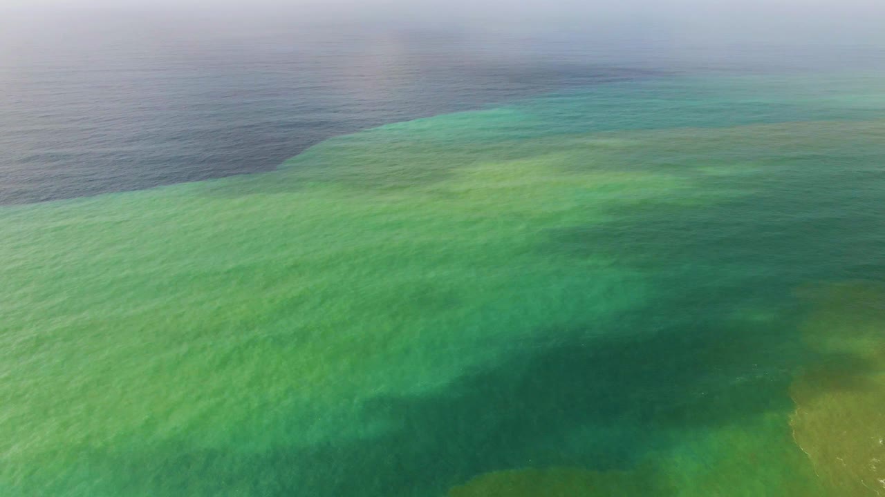 Aerial view over Punta Gorda East Cape, Baja California Sur, showing turquoise shallow water blending into darker ocean water, with no visible people.