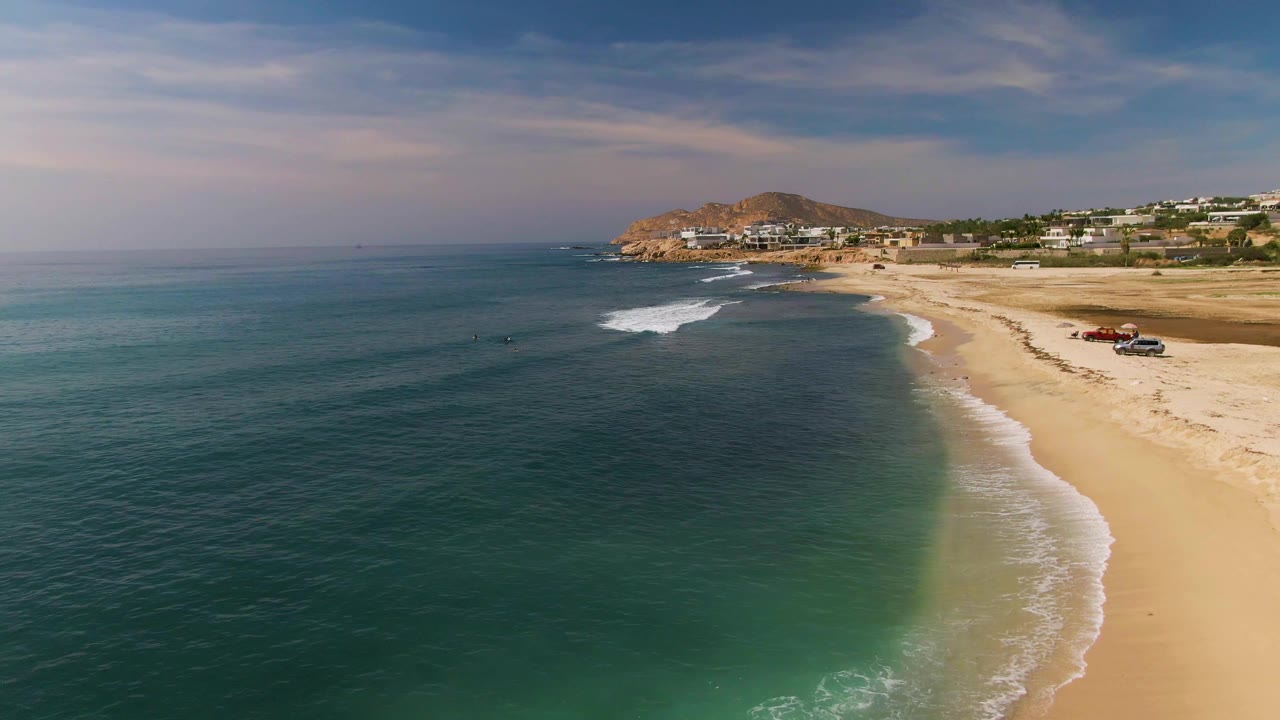 Ocean foreground with small breaking waves along the beach.