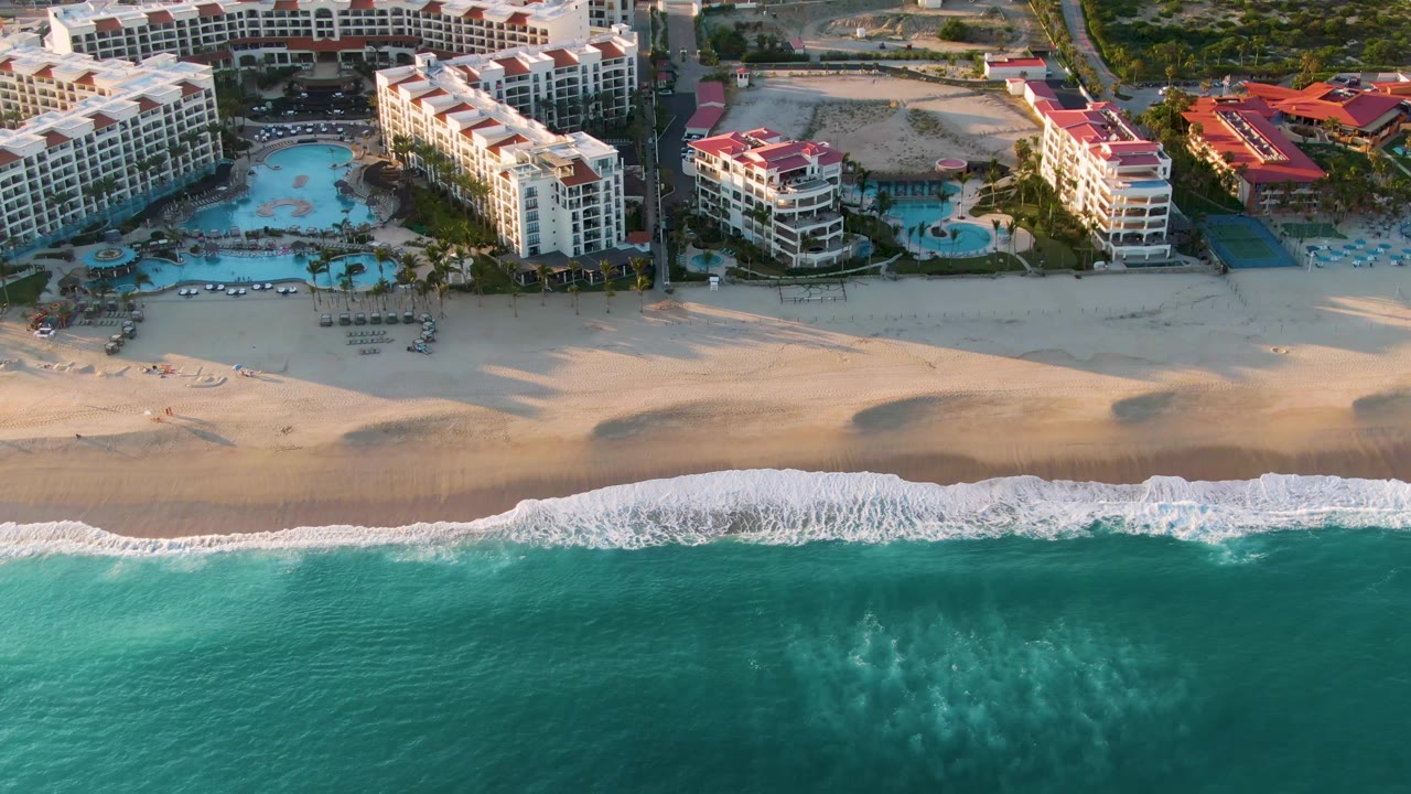 Aerial resort beach view with wave foam along the lower shoreline