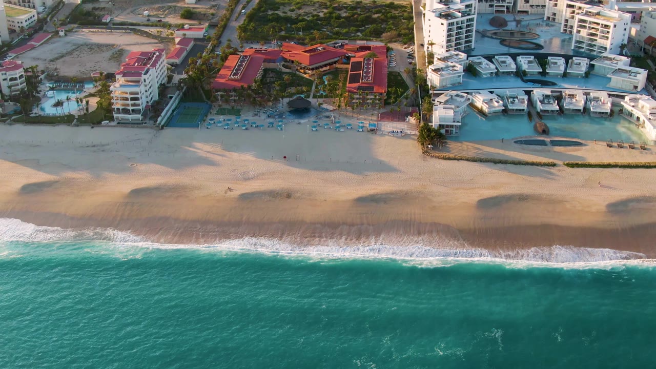 Aerial shoreline with ocean foam and resort complex