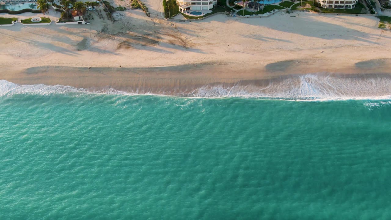 Aerial beach view with turquoise water and a smoother wet sand line