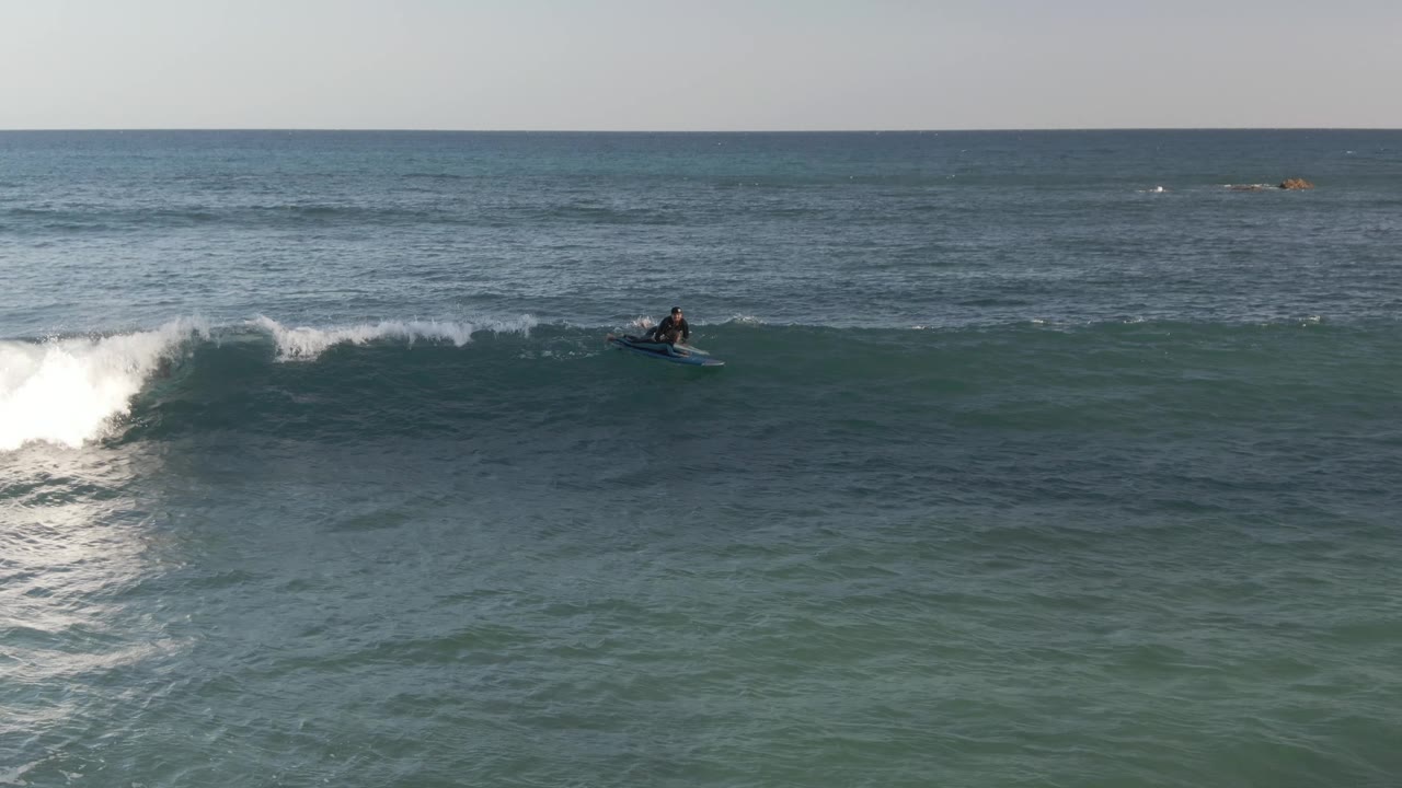 Surfer on a wave as whitewater begins to break.