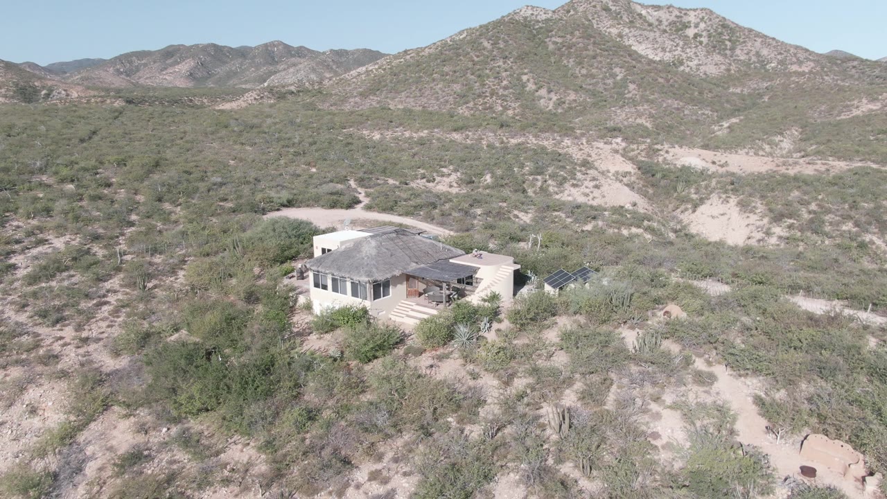 Desert home at the edge of open scrub and mountain slopes